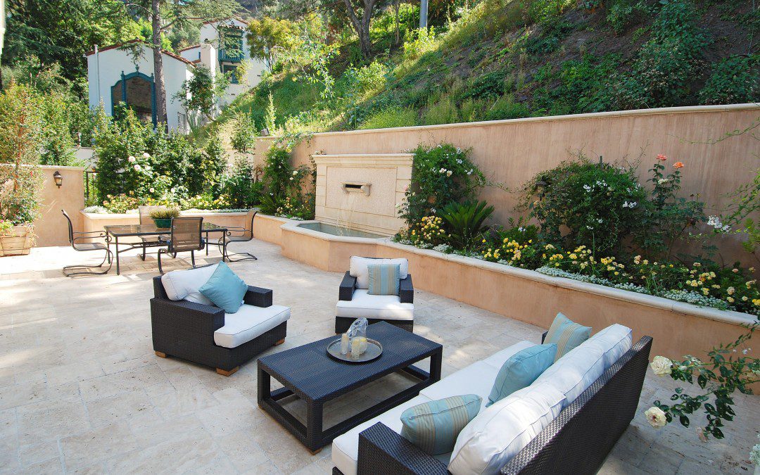 An outdoor patio with furniture and a fire pit.