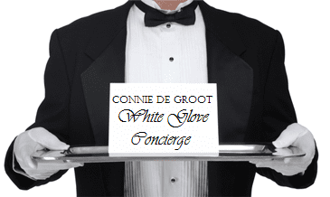 A man in a tuxedo holding a tray that says come be ghost.