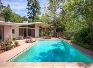 A home with a swimming pool in the backyard.